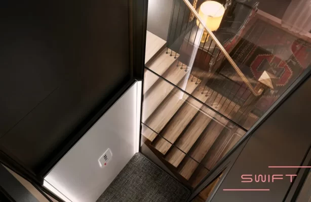 A modern elevator with a glass wall and a light.